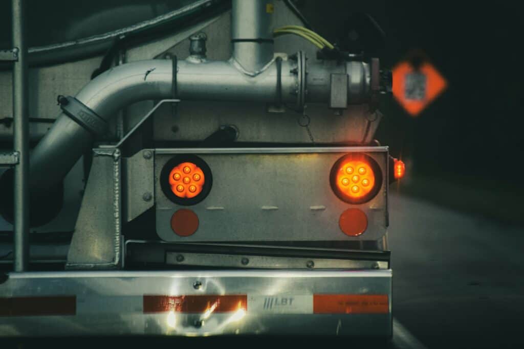 Close-up of a truck's rear lights glowing at night, showing why reliable trailer lighting matters